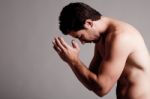 Shirtless Man Praying Stock Photo