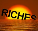 Riches Word Sinking In Sea Stock Photo