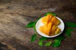 Croissant On Dish With Rice Green Tea Leaves  On Old Wooden Stock Photo