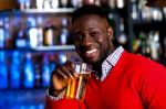 Guy Drinking Beer In A Nightclub Stock Photo