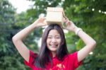 Portrait Of Thai Teen Beautiful Girl In Chinese Dress, Happy New Year And Open Box Gift, Smile And Very Happy Stock Photo