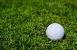 A Glof Ball On Green Field Stock Photo