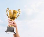 Kid Holding The Golden Trophy Stock Photo