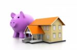 Piggy Bank And A House Model Stock Photo