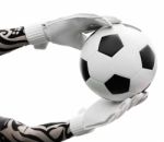 Goalkeeper's Hands Catching The Soccer Ball On White Background Stock Photo