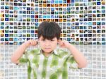 Kid Protecting Ears From Noise Stock Photo