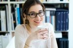 Young Worker Woman Having Coffee In Her Office Stock Photo