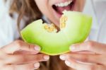 Young Woman In Underwear Eating Melon. Isolated On White Stock Photo