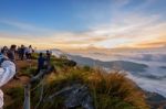 Chiang Rai, Thailand-oct. 25 2016:  Group Of Tourist Taking Photos And Waiting For The Sunrise Over The Cloud Scape On Peak Mountains In Winter At Phu Chi Fa Forest Park, Chiang Rai Province In Thailand Stock Photo