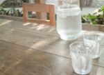 Double Glasses Of Cold Water On Wooden Table Stock Photo