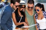 Group Of Friends Use Their Map In The Street Stock Photo