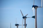 Green Renewable Energy Concept - Wind Generator Turbines On Blue Stock Photo