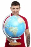 Smiling Tattoo Guy Showing Globe Stock Photo