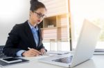 Attractive Women In Casual Business Sitting At A Table Working O Stock Photo