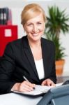 Female Secretary Writing On Notepad Stock Photo