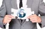 Businessman Holding Mismatch Jigsaw Stock Photo