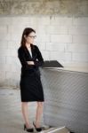 Business Woman Standing Thoughtful In A Building Stock Photo