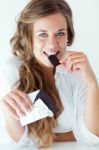 Young Woman In Underwear Eating Chocolate. Isolated On White Stock Photo