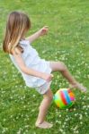 Happy Little Girl Playing Ball In The Park Stock Photo