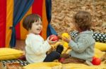 Children Play In The Park And Eating Apple Stock Photo