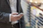 Businessman With Smartphone In Business Building Stock Photo