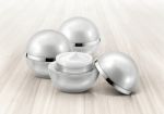 Silver Sphere Cosmetic Jar On Wood Background Stock Photo