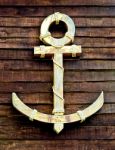 The Old Wooden Anchor On Wood Wall Background Stock Photo