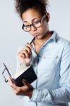 Pretty Young Black Woman Taking Notes At Home Stock Photo