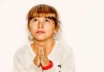 Beautiful Little Girl Praying And Looking Up, Isolated On White Stock Photo