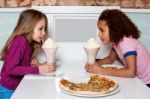 Young Girls Sipping Strawberry Shake Stock Photo