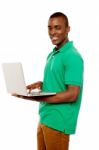 Smiling African Guy Using Laptop Stock Photo