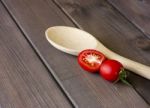 Fresh Tomatoes And Spoon On The Dark Wooden Table Stock Photo