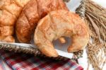 Delicious Fresh Croissants With Rice On Wooden Background Stock Photo