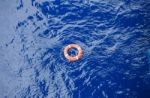 Life Buoy Bound With Rope Rescue Floating In The Sea Stock Photo