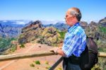 Caucasian Man Viewing Rocky Mountains In Landscape Stock Photo