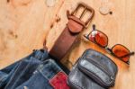 Leather And Jeans On Wooden Stock Photo