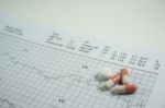 Heap Of Medicine Pills On Cardiogram Grid Paper. Selective Focus Stock Photo