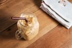 Ice Coffee With Milk And Newspaper On Table Stock Photo