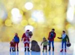 Miniature Santa Claus And Family With Beautiful Light Bokeh Back Stock Photo