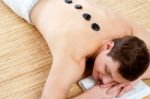 Man Receiving Stone Therapy Massage Stock Photo