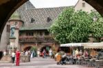 View Of A Statue And A Group Of People Sightseeing In A Courtyar Stock Photo