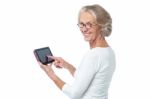 Aged Lady Operating Touch Pad Device Stock Photo