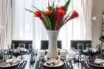 Flower In Vase On Modern Dinning Table Stock Photo