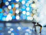 Miniature Camera Man With Beautiful Light Bokeh Background. Chri Stock Photo