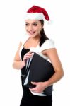 Female Employee Holding Files Wearing Santa Cap Stock Photo