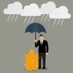 Businessman With Umbrella Protecting His Money From Financial Cr Stock Photo