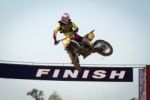 Red Motocross Winner Jump Stock Photo