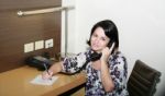 Young Woman Sitting Ready To Take Notes Stock Photo