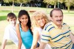 Portrait Of Family Relaxing In Park Stock Photo