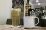 Hot Coffee And Iced Coffee On Wooden Table Stock Photo